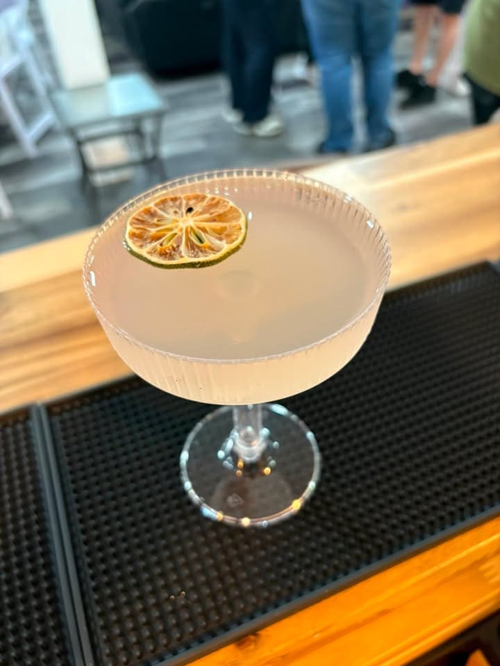 Signature lavender cocktail with gold-rimmed coupe